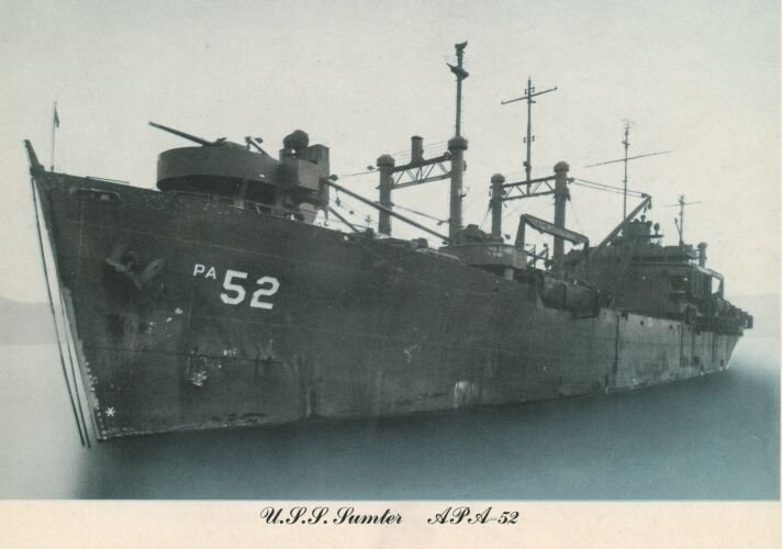 USS Sumter (APA-52), an attack transport, photographed at anchor, hull number PA 52 visible on the bow